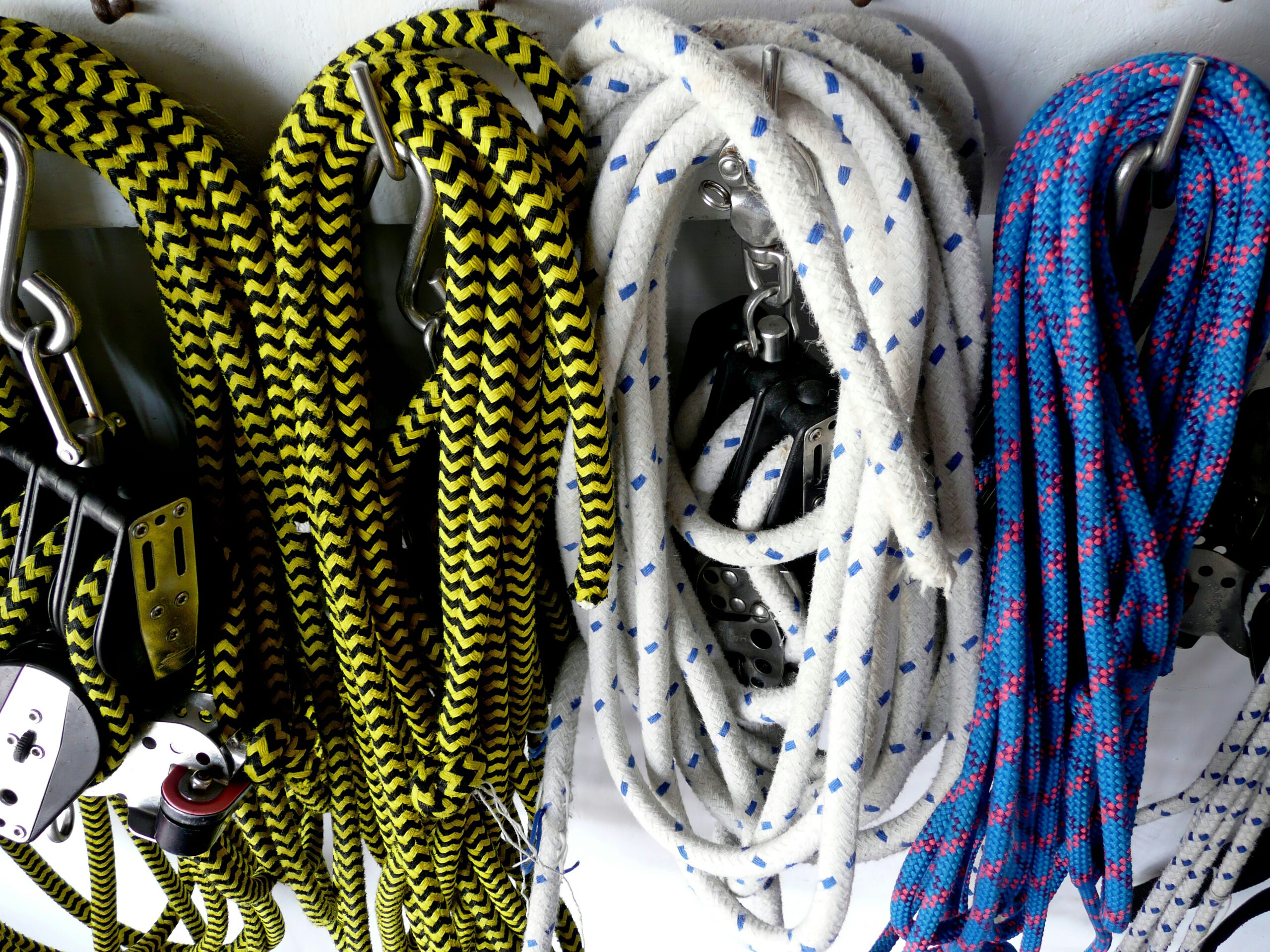 Various styles of climbing harnesses laid out side by side