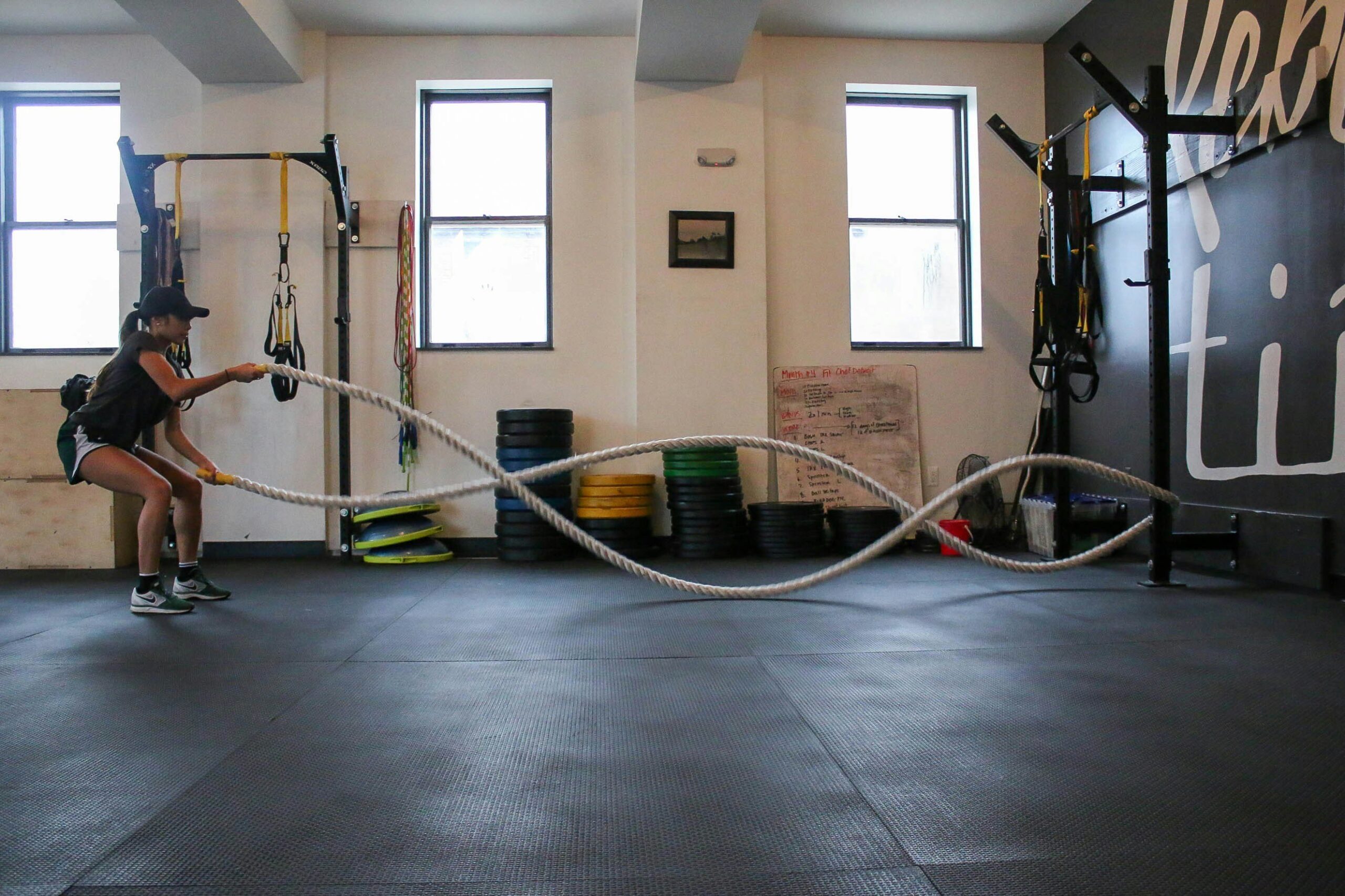 A person ascending a thick rope using proper form