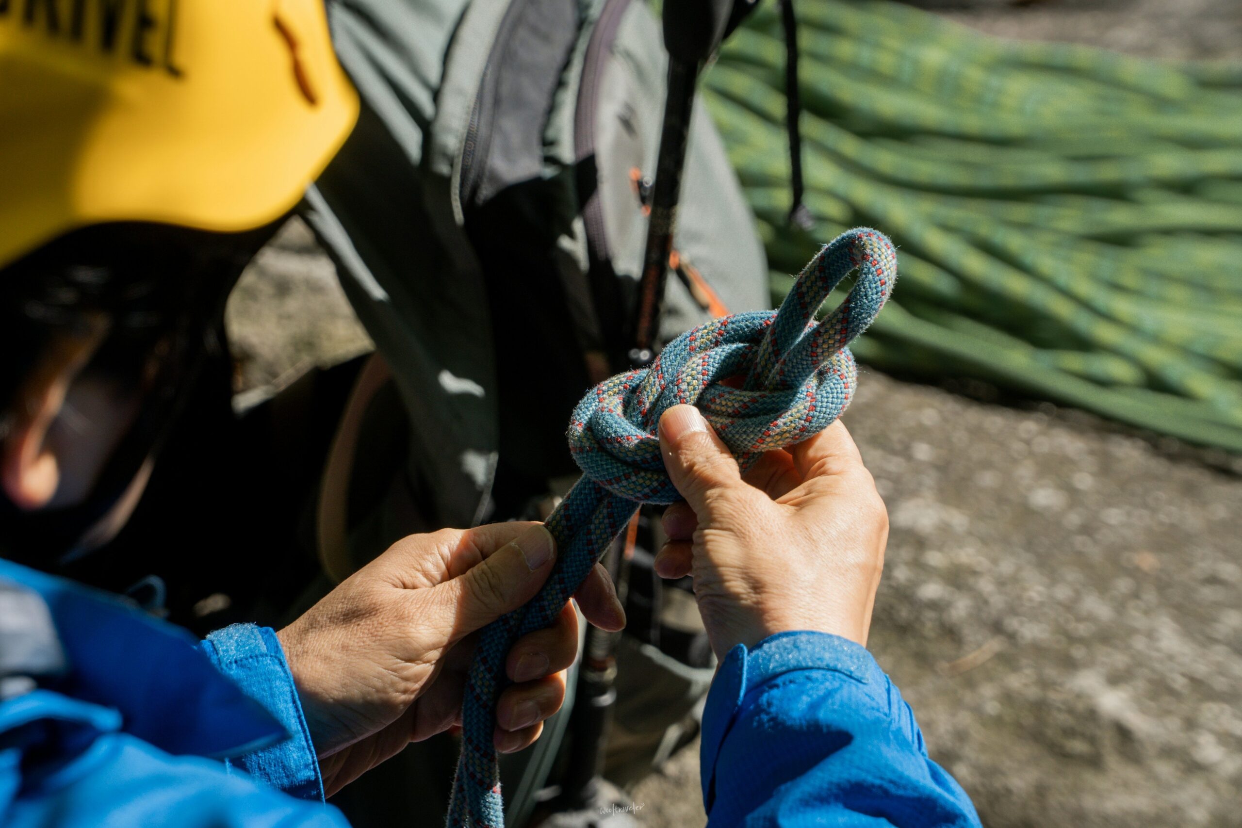 A woman smiling after completing a challenging climb with an adjustable body lock harness