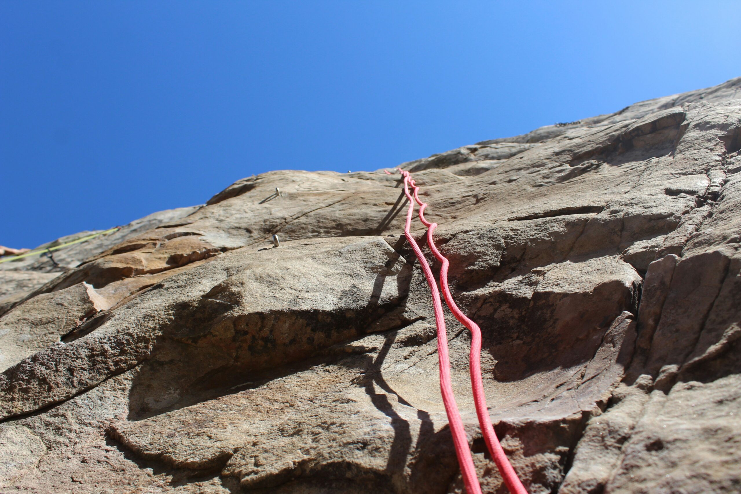 Climber struggling with ill-fitting harness