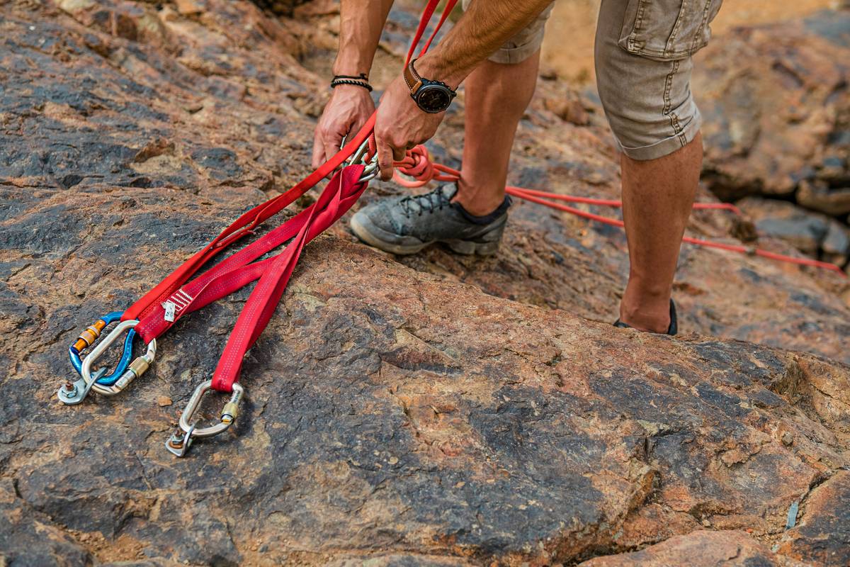 A climber wearing a properly fitted body lock harness mid-climb