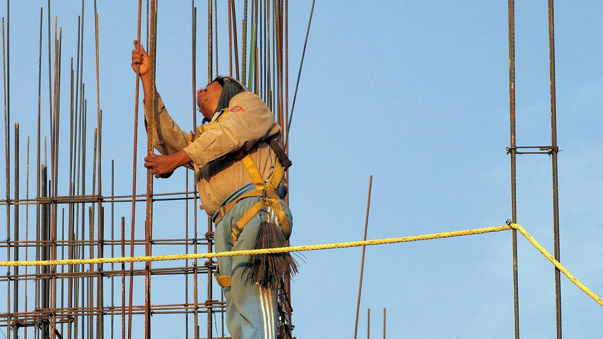 Climber adjusting straps on a high-quality climbing harness