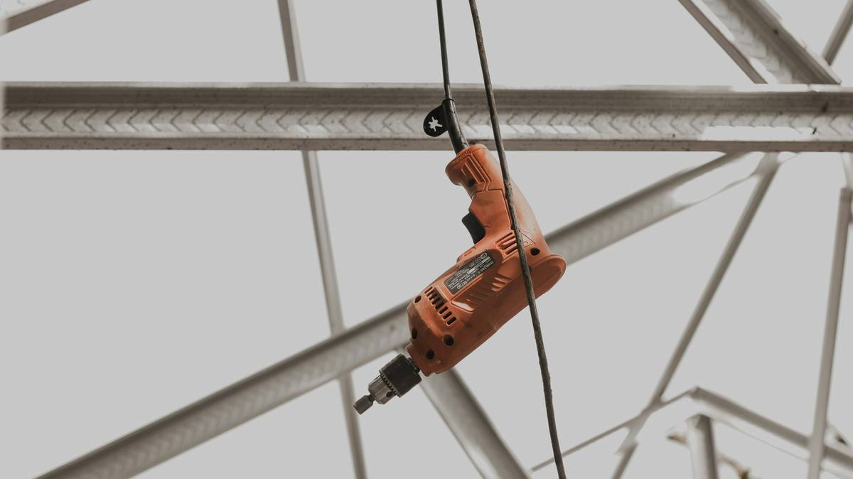 Climber inspecting the load rating on her harness tag against sunlight